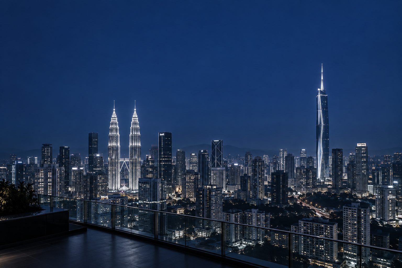 The Kuala Lumpur skyline at dusk from a rooftop terrace, the towers lit against a deep navy sky